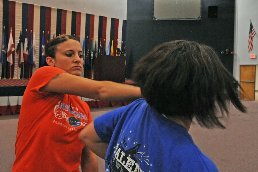 BARKSDALE AIR FORCE BASE, La. -- Staff Sgt. Kari Payne, 2d Force Support Squadron’s, assistant base personnel reliability program manager, demonstrates the push drill on Airman 1st Class Patricia Howk, 2d Comptroller Squadron special actions technician, during the women's self-defense training class at Hoban Hall here April 29. More than 20 participants attended the women’s self-defense class, where they were taught many different techniques. (U.S. Air Force photo by Senior Airman La’Shanette V. Garrett) (RELEASED)