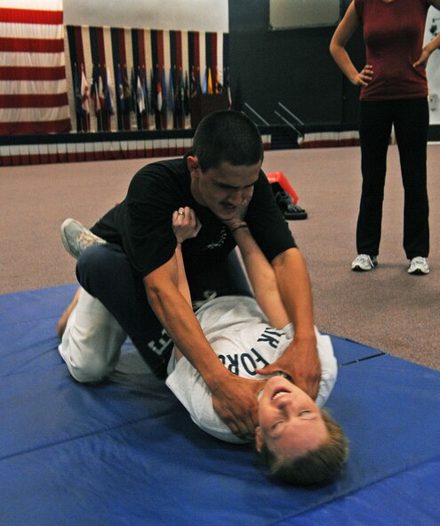 BARKSDALE AIR FORCE BASE, La. -- Johnathan Hasty, self-defense instructor, and Senior Airman Justine Digman, 2d Contracting Squadron contracting specialist, demonstrate how to evade a sexual assault during a self-defense training class at Hoban Hall here April 29. More than 20 participants attended the women’s self-defense class, where they were taught many different self-defense techniques. (U.S. Air Force photo by Senior Airman La’Shanette V. Garrett) (RELEASED)