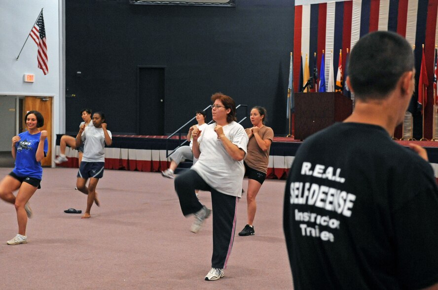 BARKSDALE AIR FORCE BASE, La. -- Women participating in the women's self-defense class warm-up by executing front kicks at Hoban Hall here April 29. More than 20 participants attended the women’s self-defense class, where they were taught many different techniques. (U.S. Air Force photo by Senior Airman La’Shanette V. Garrett) (RELEASED)