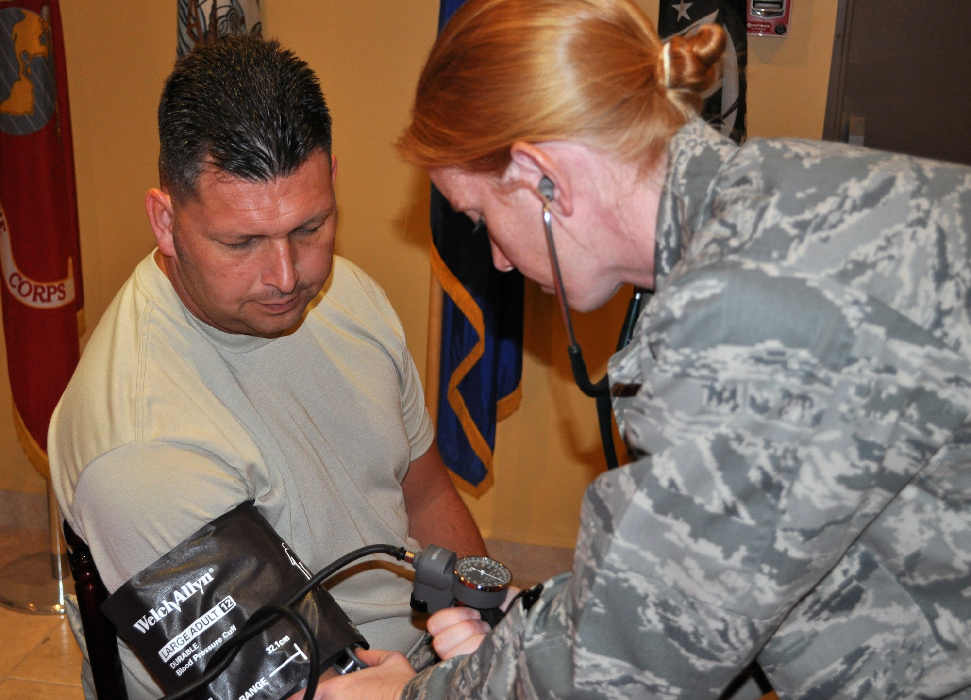 U.S. Air Force Capt. Nicole Gramlick, 386th Expeditionary Medical Group nurse, checks the blood pressure of Senior Master Sgt. William Finch, 386th Expeditionary Civil Engineer Squadron fire chief, during a health fair April 14, 2010 at an air base in Southwest Asia. (U.S. Air Force photo by Capt. Mollie Robinson/Released)