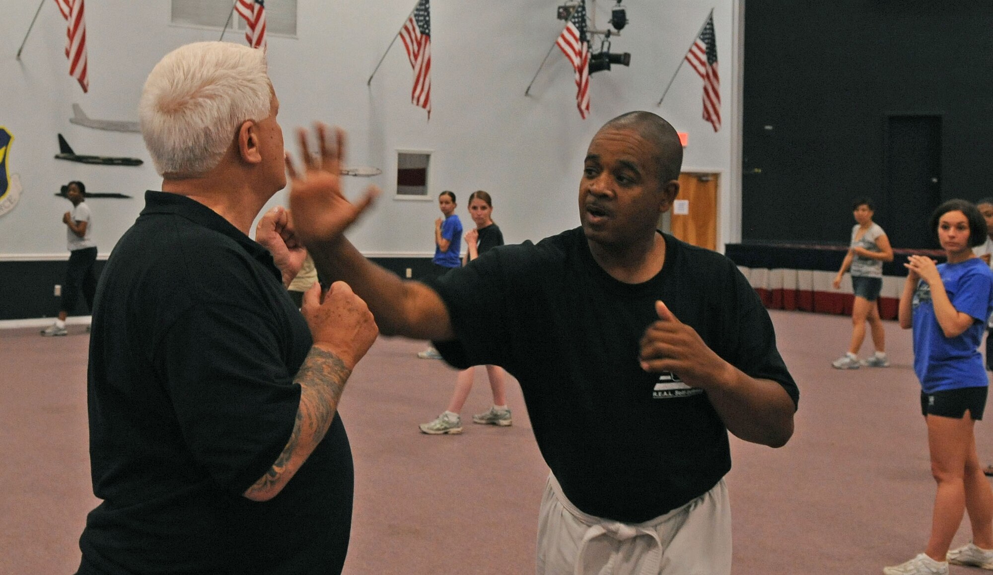 BARKSDALE AIR FORCE BASE, La. -- Self-defense instructors Lenner Newman and Bill Payne demonstrate a palm-heel attack to the women’s self-defense class at Hoban Hall here April 29. More than 20 participants attended the women’s self-defense class, where they were taught many different techniques. (U.S. Air Force photo by Senior Airman La’Shanette V. Garrett) (RELEASED)