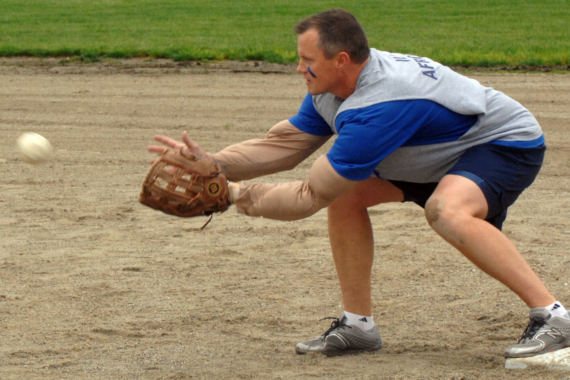 GRISSOM AIR RESERVE BASE, Ind., -- James West, a KC-135R Stratotanker pilot with 72nd Air Refueling Squadron, prepares to catch the ball forcing out a runner at first base during the annual Jovanovich Cup softball game held in May. The 72nd ARS "Dark Side" rallied to beat the 74th ARS "Fighting Red Tags" 10-8. (U.S. Air Force photo/Tech. Sgt. Doug Hays)