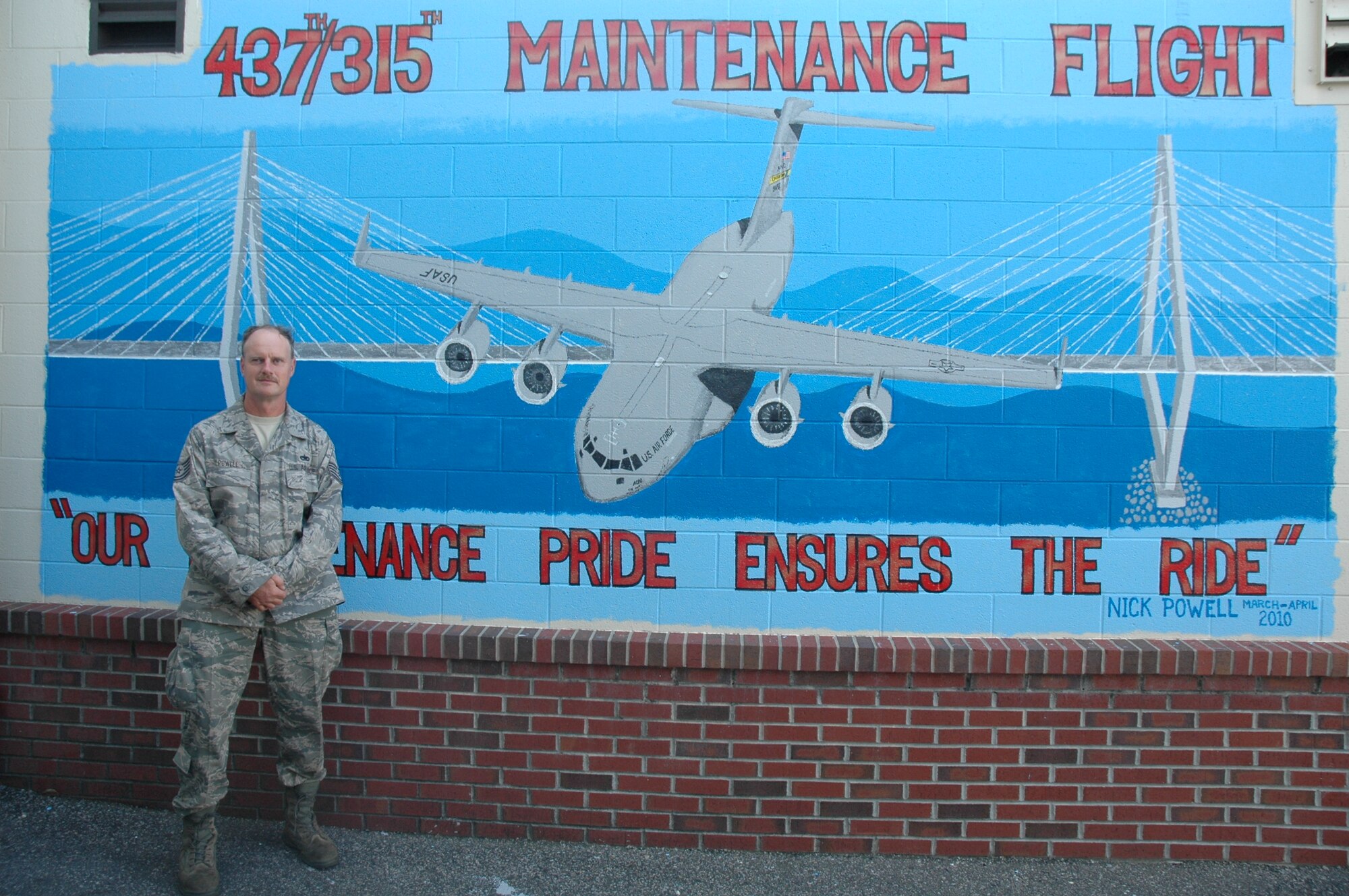 Tech. Sergeant Nicholas Powell stands in front his latest mural at hanger 700, Charleston Air Force Base, S.C. Sergeant Powell is a crew chief with  the 315th Airlift Wing Maintenance Squadron. (U.S. Air Force Photo/SrA Dani Shea)