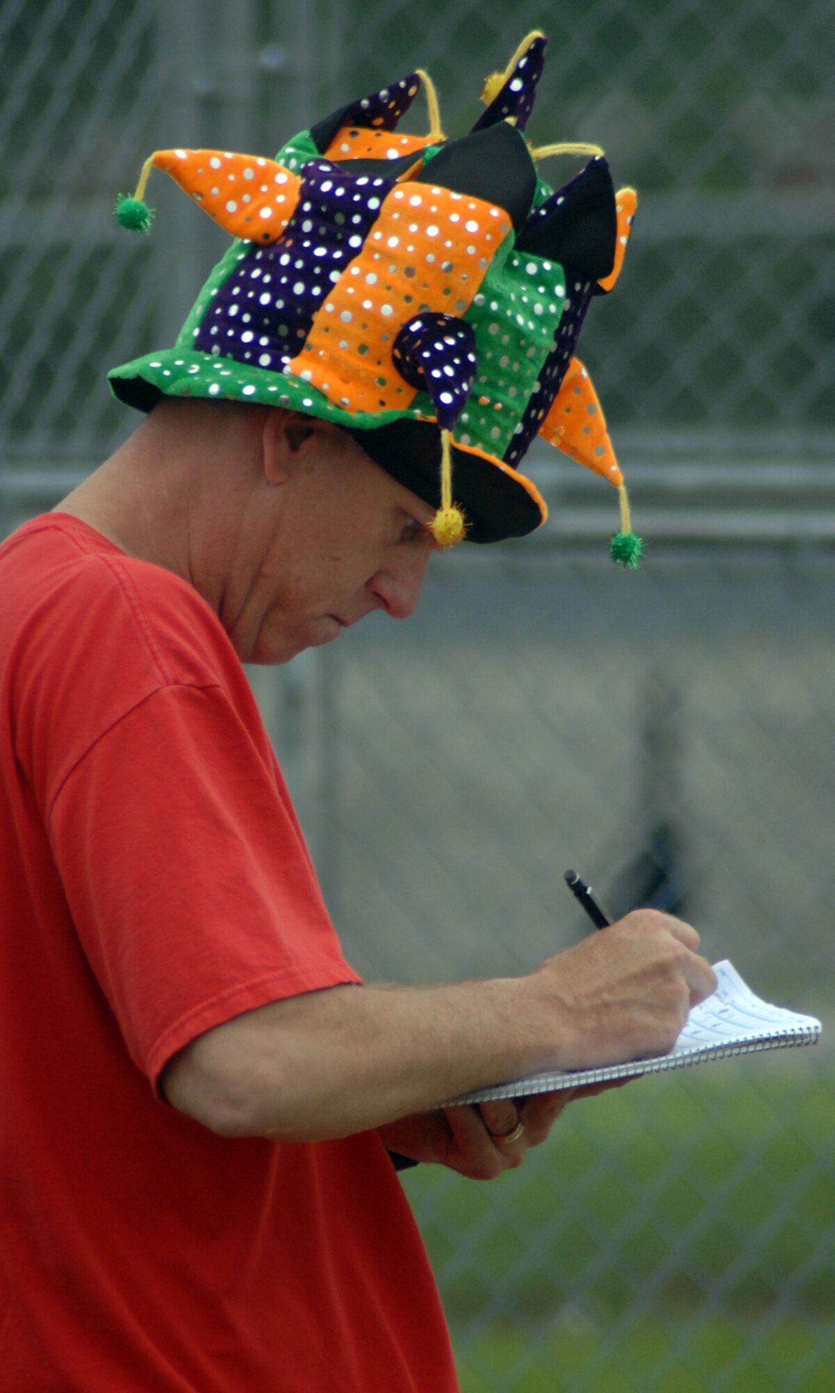 GRISSOM AIR RESERVE BASE, Ind., -- Larry Shaw, 74th Air Refueling Squadron operations officer, keeps the book and manages the Fightin' Red Tags team as they play the 72nd ARS Dark Side team in the annual Jovanovich Cup softball game. Despite Shaw's efforts and wardrobe, the Dark Siders rallied to win 10-8.  (U.S. Air Force photo/Tech. Sgt. Doug Hays)