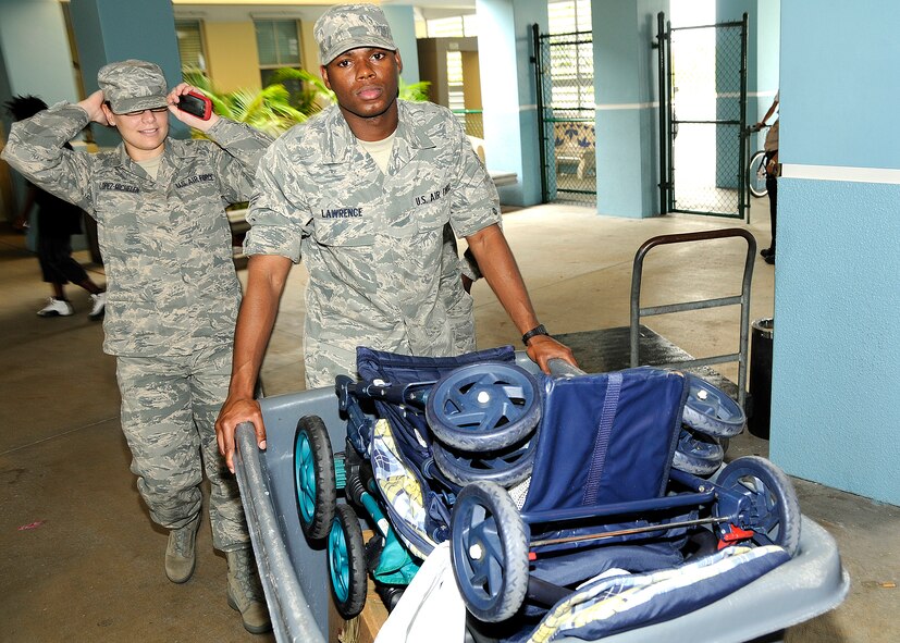 Senior Airman Johnny Lawrence, right, and Senior Airman Astrid Lopez-Michelen, Junior Enlisted Council members at Homestead Air Reserve Base, Fla., take needed baby supplies to the Homestead Community Partnership for Homeless. "The people that come here have nothing, they are just starting to get their lives back together and these donations help them do that - these are the things we use every day," said Ruth V. Cardona, Assistant Center Coordinator for Homestead CPH. (U.S. Air Force photo/Senior Airman Lou Burton)