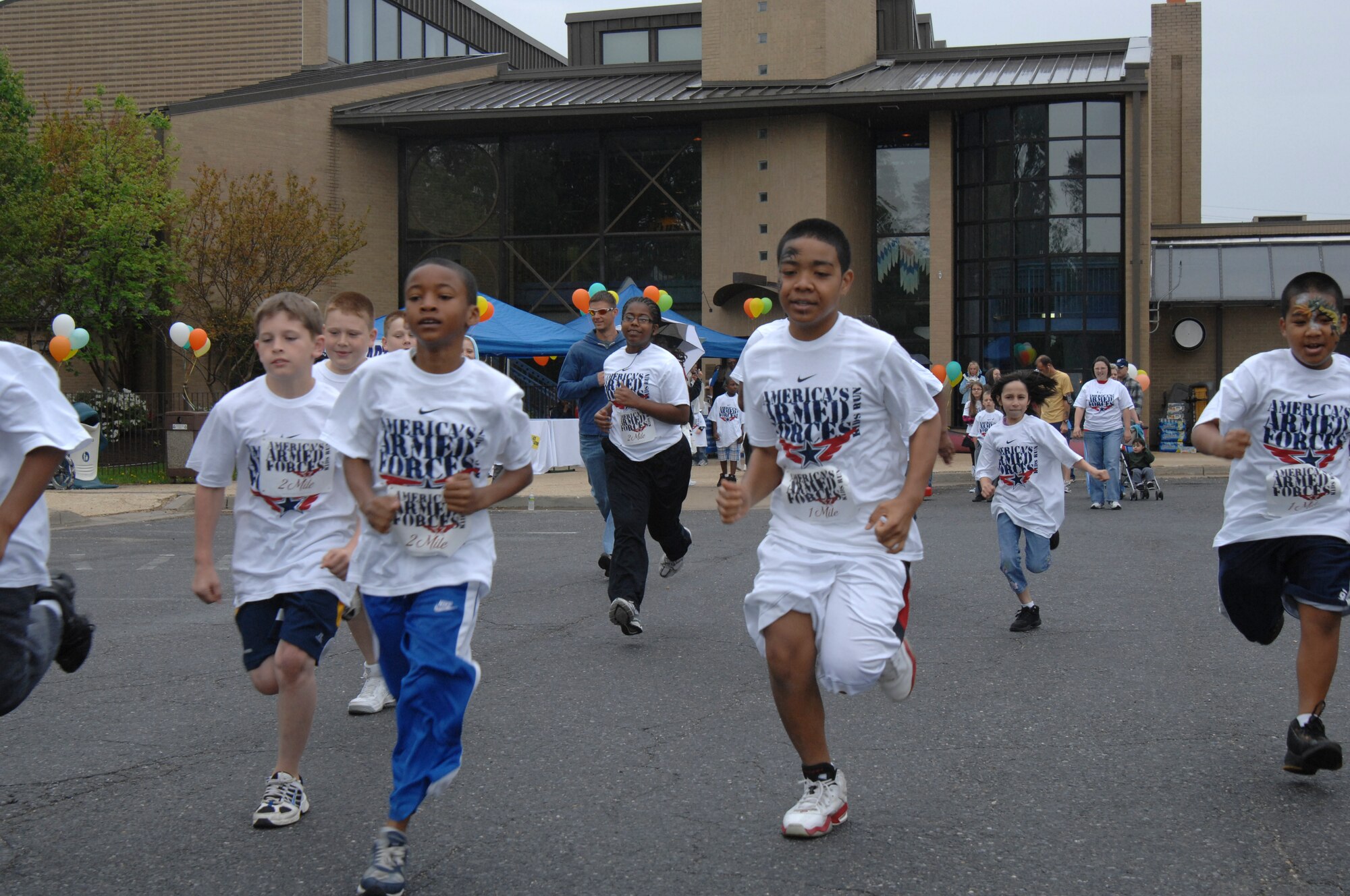 Several Andrews children start out on a Adult and Kid Run during Family Fest 2010 April 24 in front of the Joint Base Andrews, Md., Youth Center. The  event, which ran from 11 a.m. to 3 p.m., included demonstrations of exercises, activities and healthy eating habits for children and parents. The children also received points for completing exercises at each exercise station. Sponsored by the Andrews Youth Center, participants were treated to food and refreshments. The event concluded with an awards ceremony and acknowledgments. 