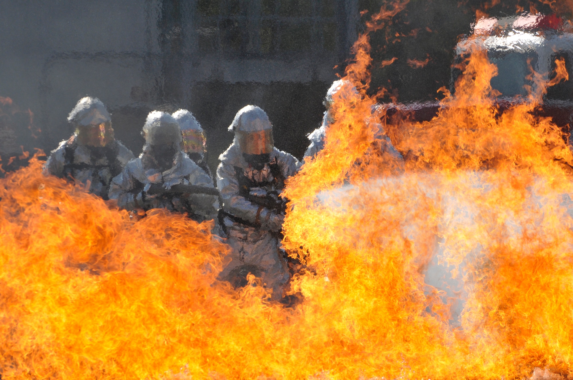 Firefighters from the 125th Fighter Wing Jacksonville, Fl, and 71st Fighter Wing, Langley, Va, extinguish a fire in a burn pit at the Combat Readiness Training Center (CRTC), Savannah, GA, March 13, 2010. The burn pit  is a  live fire training simulator and re-creates most scenarios of a real aircraft fire. (Air Force Photo by Tech. Sgt. Shelley Gill)