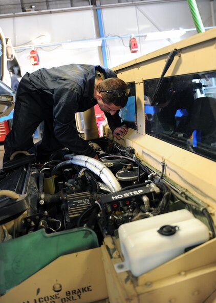 MINOT AIR FORCE BASE, N.D. -- Airman 1st Class Jeremy Smith, 5th Logistics Readiness Squadron vehicle maintenance apprentice, works on the engine of a high mobility multipurpose wheeled vehicle, or Humvee, here April 27.  These vehicles are used by both the 5th Bomb Wing and the 91st Missile Wing security forces to defend Minot AFB and its assets.  (U.S. Air Force photo by Staff Sgt. Keith Ballard)