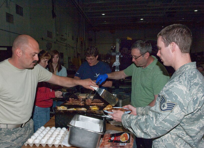 Deployers from the 133rd Airlift Wing enjoy breakfast prepared by co-workers and family members in the early morning hours on May 1, 2010 at the St. Paul Air National Guard base. Airmen departed for duty in Southwest Asia as the Minnesota Air National Guard's C-130 unit takes another turn in the combat zone. USAF photo by Senior Master Sgt. Mark Moss (Released)