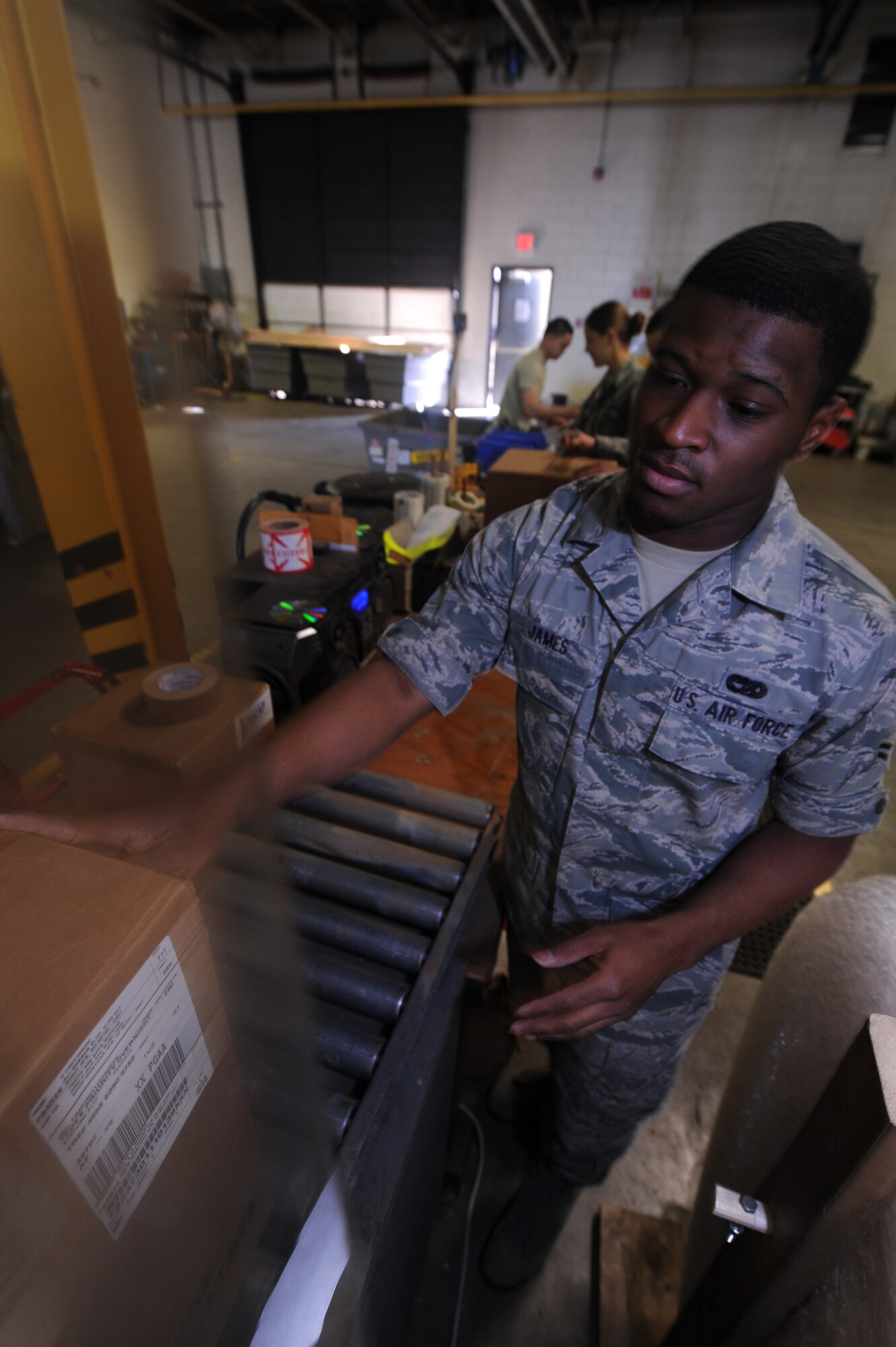 MINOT AIR FORCE BASE, N.D. -- Senior Airman Wesley James, 5th Logistics Readiness Squadron travel management apprentice, forwards the next package for delivery here April 22.  The deployment and distribution flight is responsible for the rapid and efficient movement of supplies and equipment in support of the base. (U.S. Air Force photo by Tech. Sgt. Lee A. Osberry Jr.)