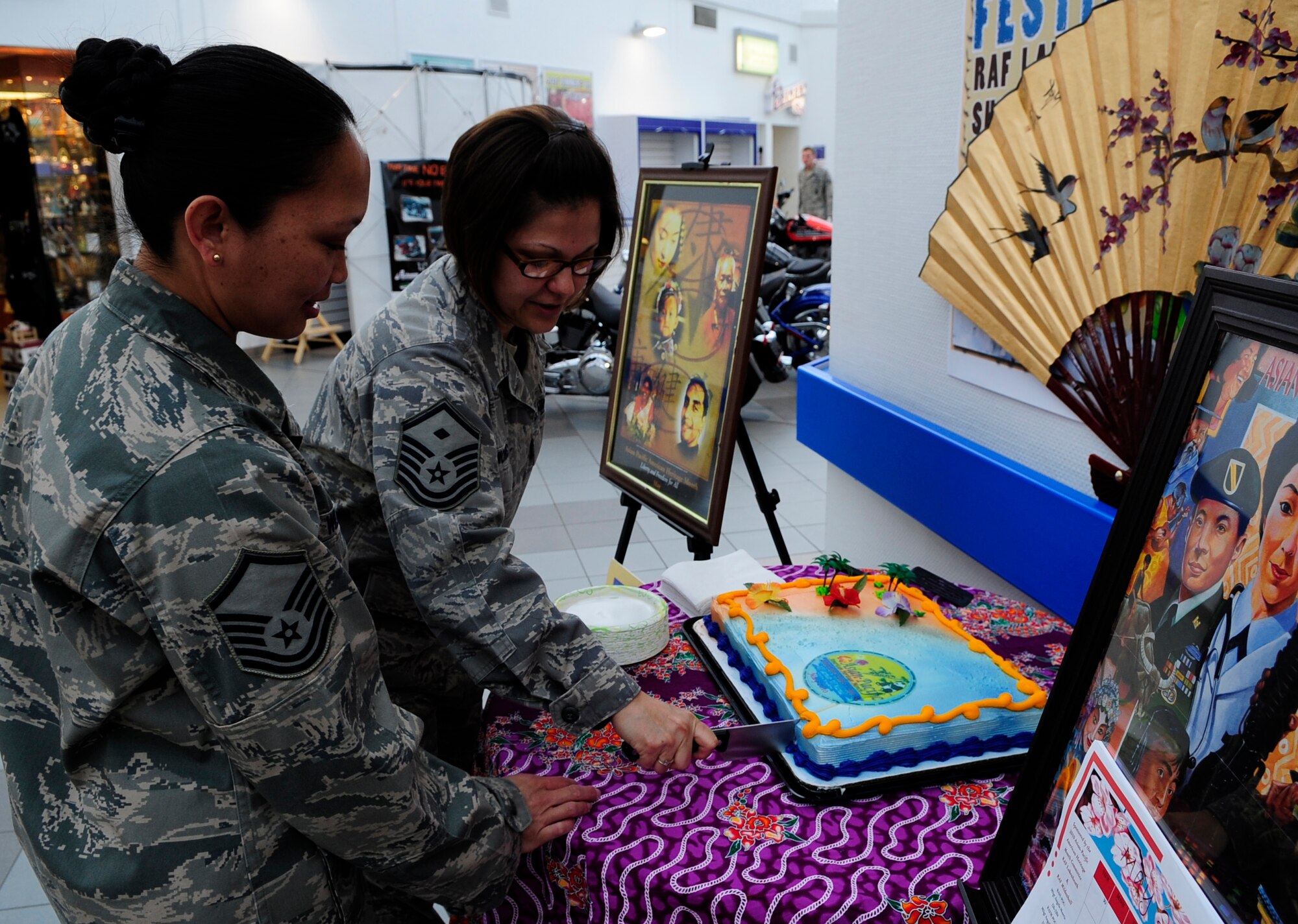 RAF MILDENHALL, England – Master Sgt. Angela Morris, 48th Munitions Squadron, and Master Sgt. Angela Willis, 352nd Special Operations Group, cut the cake marking the beginning of Asian and Pacific Islander Month May 4.   (U.S. Air Force photo/Staff Sgt. Christopher L. Ingersoll)