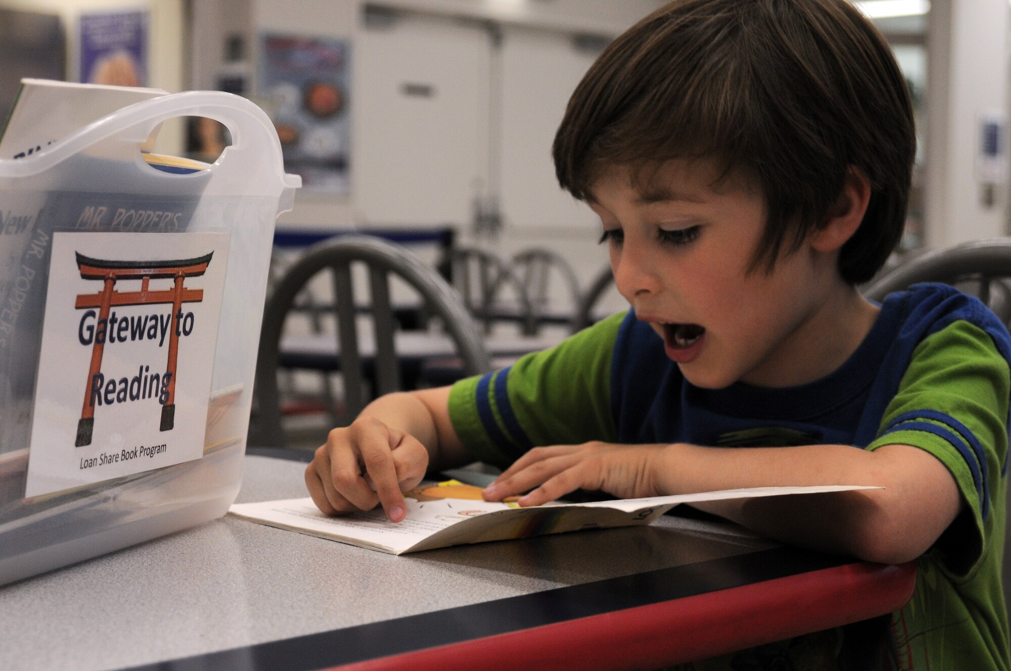 YOKOTA AIR BASE, Japan -- Andrew Goben, Yokota West Elementary School kindergatener, reads one of the books made available to him through the Gateway to Reading program, May 5. Gateway to Reading is a loan-share book program designed to make finding time to read easy for elementary school aged students. (U.S. Air Force photo/Airman 1st Class Katrina R. Menchaca)