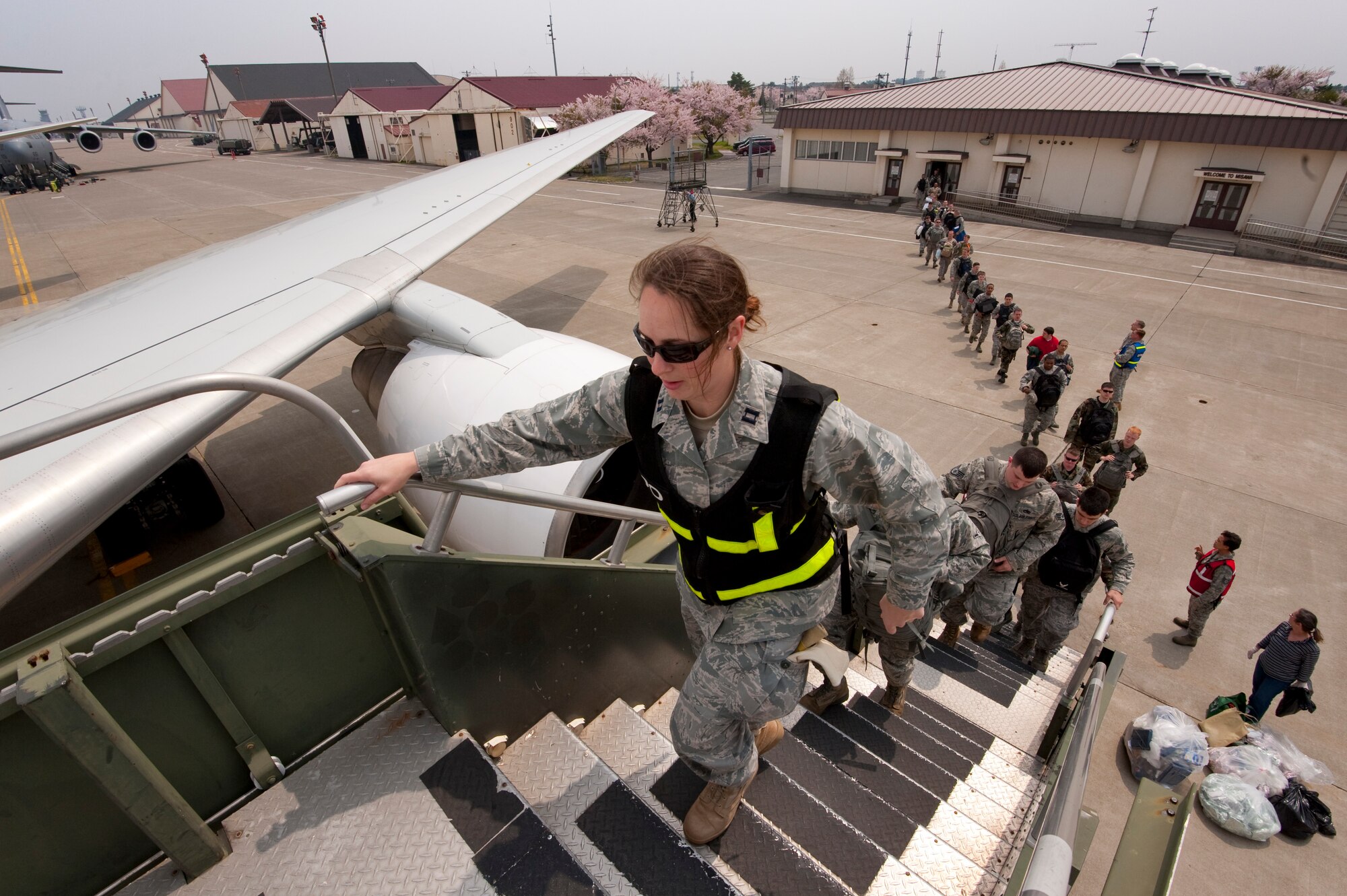 MISAWA AIR BASE, Japan -- Capt. Heather McDaniel 35th Logistics Readiness Squadron, installation deployment officer, leads Airmen of the 14th Fighter Squadron and Aircraft Maintenance Unit onto their flight May 5. Approximately 350 Airmen deployed to work alongside Republic of Korea-U.S. alliance partners to maintain peace and stability in the region. (U.S. Air Force photo/Staff Sgt. Samuel Morse)