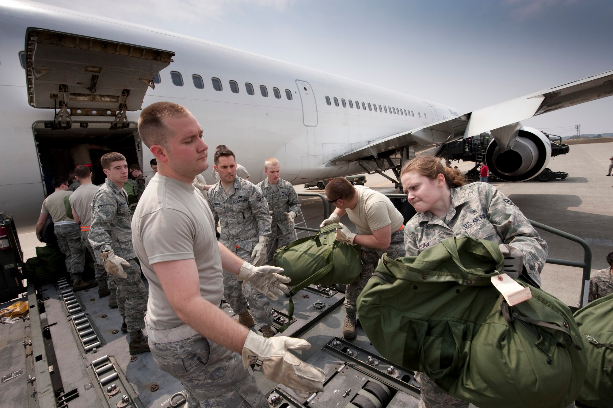 MISAWA AIR BASE, Japan -- Airmen with the 14th Fighter Squadron and Aircraft Maintenance Unit load baggage onto an aircraft May 5. The team loaded luggage for more than 350 passengers. (U.S. Air Force photo/Staff Sgt. Samuel Morse)