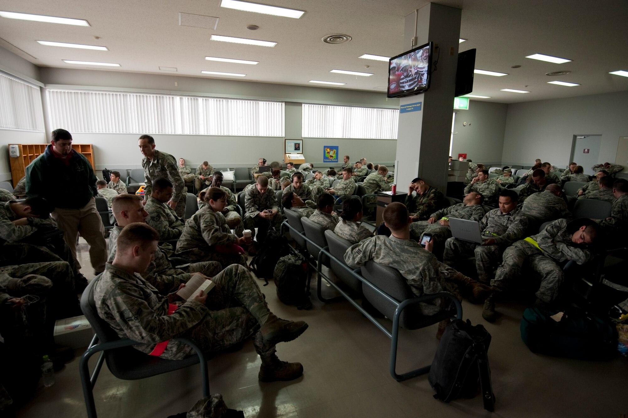 MISAWA AIR BASE, Japan -- Airmen with the 14th Fighter Squadron and 35th Aircraft Maintenance Squadron wait for their flight in the passenger terminal May 5. These Airmen deployed to the Republic of Korea in an effort to maintain regional stability in the Asia-Pacific theater and promote stronger relations with U.S. allies. (U.S. Air Force photo/Staff Sgt. Samuel Morse)
