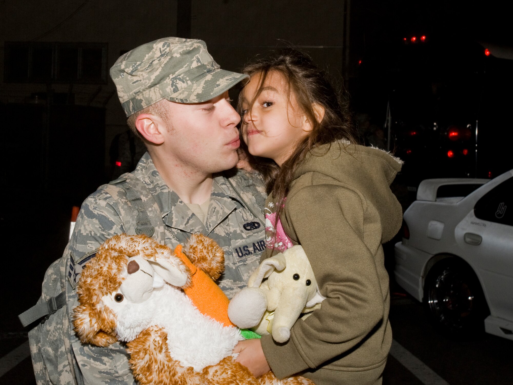 MISAWA AIR BASE, Japan -- Senior Airman Quintin Chandler, 35th Maintenance Squadron munitions-storage crew chief, kisses his daughter, Esabella, May 5 outside of Hangar 949. Airman Chandler deployed to the Republic of Korea in an effort to help maintain stability in the Asian-Pacific region. (U.S. Air Force photo/Senior Airman Jamal D. Sutter)