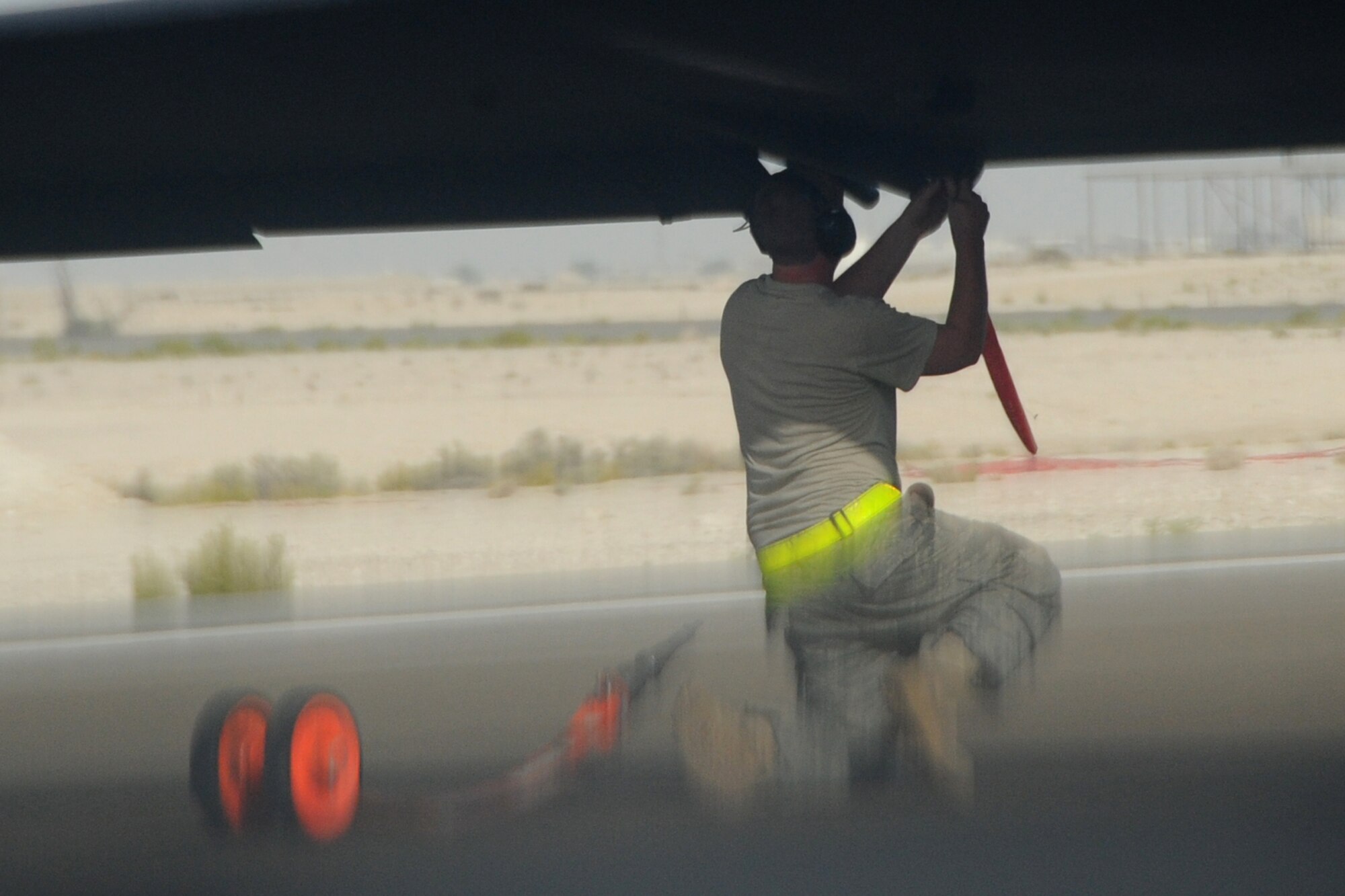 A maintainer from  the 380th Air Maintenance Squadron po-go team detach po-gos, which prevent U-2 Dragon Lady wings from becoming damaged, at an undisclosed location in Southwest Asia on April 30, 2010. The 380th Air Expeditionary Wing, supports Operations Iraqi Freedom and Enduring Freedom and the Combined Joint Task Force-Horn of Africa. The 380th AEW is comprised of four groups and 12 squadrons and the wing's deployed mission includes air refueling, surveillance and reconnaissance in support of overseas contingency operations in Southwest Asia. (U.S. Air Force photo/Senior Airman Jenifer H. Calhoun/Released)
