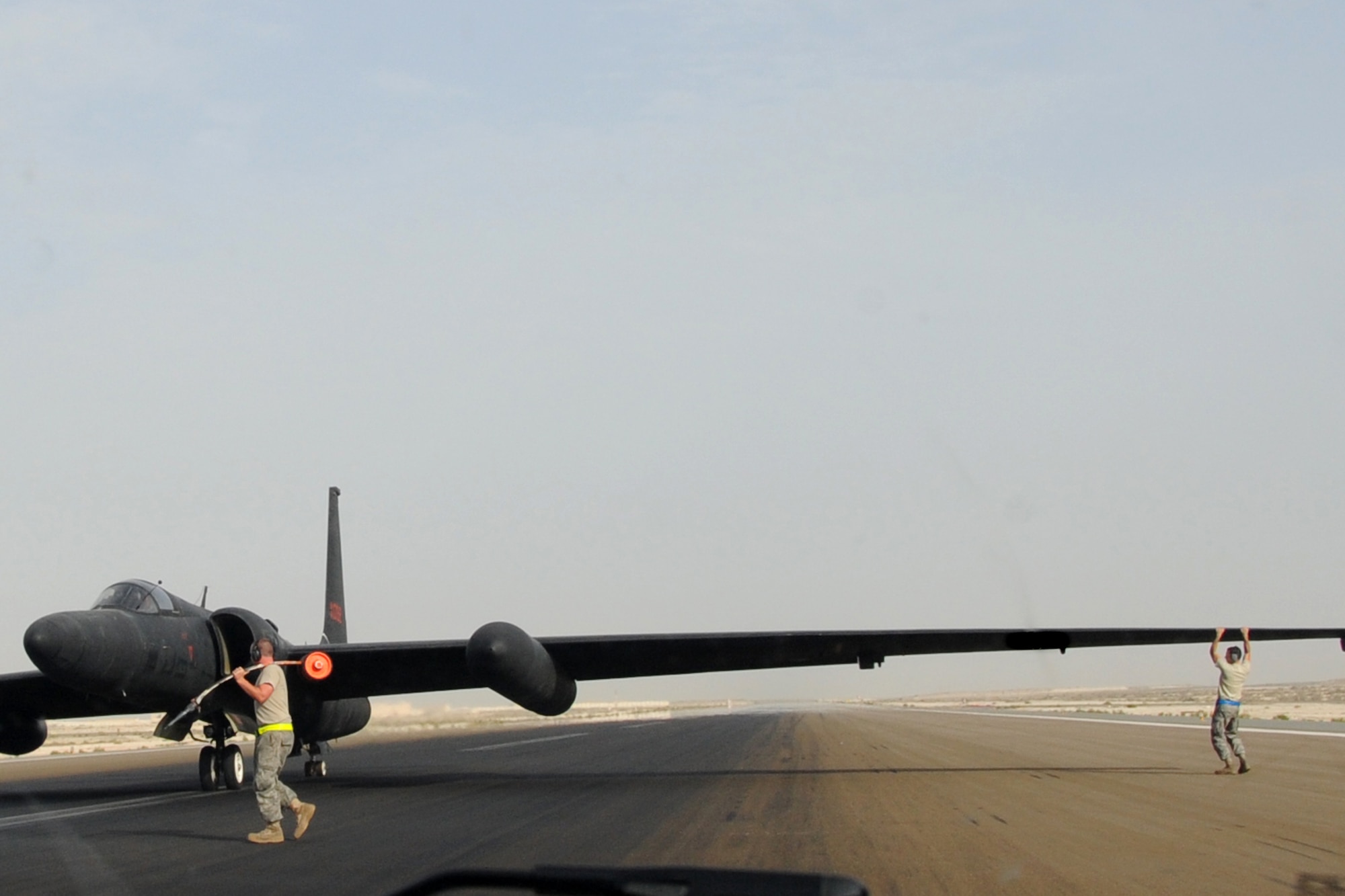 Maintainers from across the 380th Air Maintenance Squadron po-go team detach po-gos, which prevent U-2 Dragon Lady wings from becoming damaged, at an undisclosed location in Southwest Asia on April 30, 2010. The 380th Air Expeditionary Wing, supports Operations Iraqi Freedom and Enduring Freedom and the Combined Joint Task Force-Horn of Africa. The 380th AEW is comprised of four groups and 12 squadrons and the wing's deployed mission includes air refueling, surveillance and reconnaissance in support of overseas contingency operations in Southwest Asia. (U.S. Air Force photo/Senior Airman Jenifer H. Calhoun/Released)
