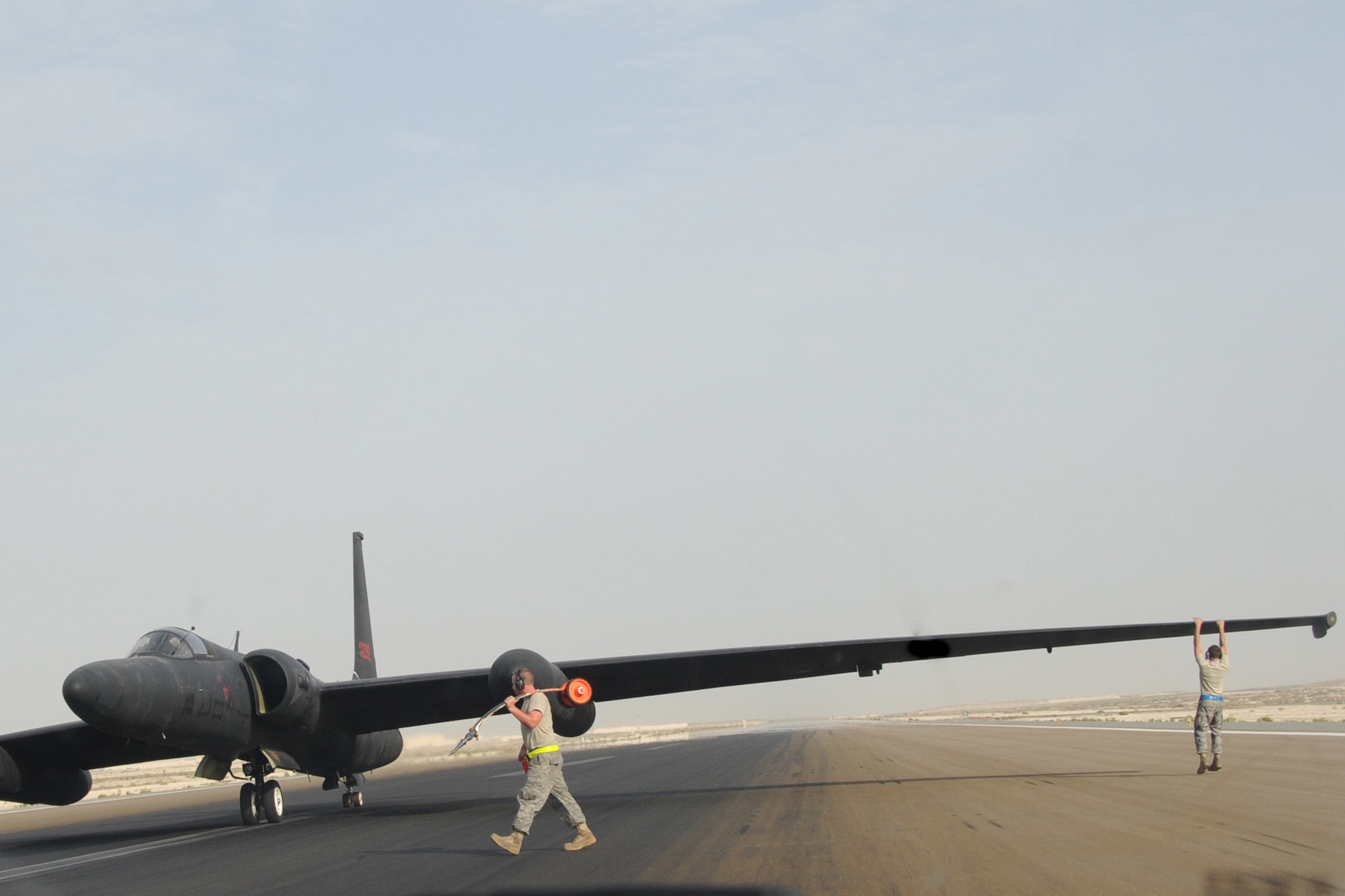 Maintainers from across the 380th Air Maintenance Squadron po-go team detach po-gos, which prevent U-2 Dragon Lady wings from becoming damaged, at an undisclosed location in Southwest Asia on April 30, 2010. The 380th Air Expeditionary Wing, supports Operations Iraqi Freedom and Enduring Freedom and the Combined Joint Task Force-Horn of Africa. The 380th AEW is comprised of four groups and 12 squadrons and the wing's deployed mission includes air refueling, surveillance and reconnaissance in support of overseas contingency operations in Southwest Asia. (U.S. Air Force photo/Senior Airman Jenifer H. Calhoun/Released)
