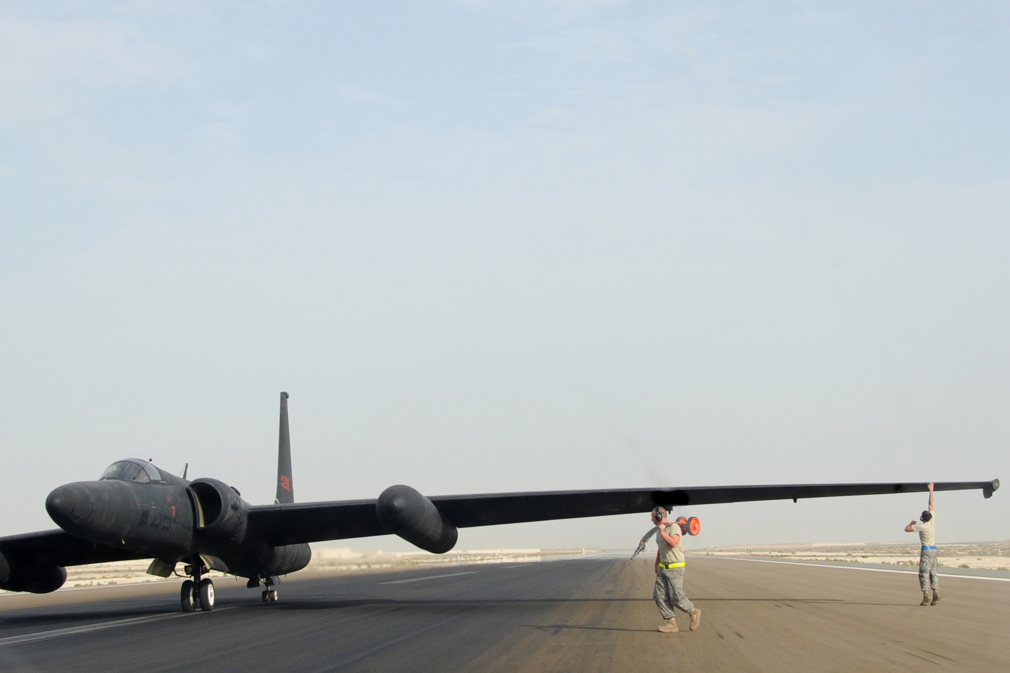 Maintainers from across the 380th Air Maintenance Squadron po-go team detach po-gos, which prevent U-2 Dragon Lady wings from becoming damaged, at an undisclosed location in Southwest Asia on April 30, 2010. The 380th Air Expeditionary Wing, supports Operations Iraqi Freedom and Enduring Freedom and the Combined Joint Task Force-Horn of Africa. The 380th AEW is comprised of four groups and 12 squadrons and the wing's deployed mission includes air refueling, surveillance and reconnaissance in support of overseas contingency operations in Southwest Asia. (U.S. Air Force photo/Senior Airman Jenifer H. Calhoun/Released)
