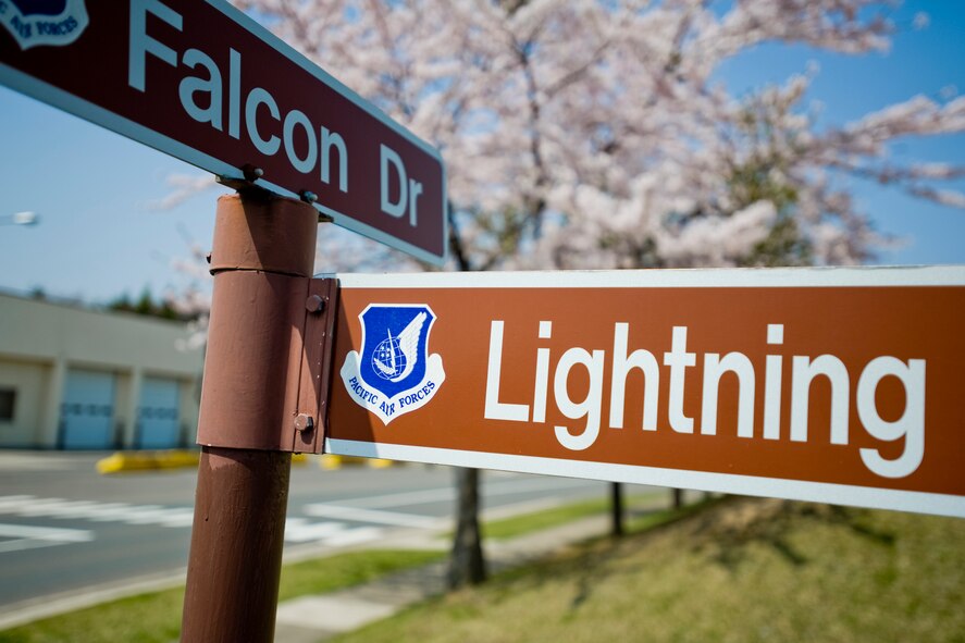 MISAWA AIR BASE, Japan -- A street sign at the corner of Falcon Drive and Lightning Loop stands in the foreground of blooming cherry blossom trees May 4 at the north area of base. Cherry blossoms, known as sakura in the Japanese language, provide a unique landscaping element to the base and take a prominent position in Japanese culture. (U.S. Air Force photo/Senior Airman Jamal D. Sutter)