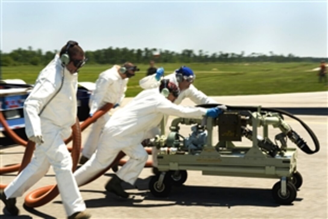 A team of U.S. Air Force aerial spray aircraft maintainers move a chemical pump into position in order to refill a chemical dispersing C-130 aircraft at Stennis International Airport in Kiln, Miss.,
May 4, 2010. The airmen are assigned to the 910th Aircraft Maintenance Squadron at Youngstown-Warren Air Reserve Station, Ohio. Members of the 910th Airlift Wing were in Mississippi to help with the oil spill clean up.