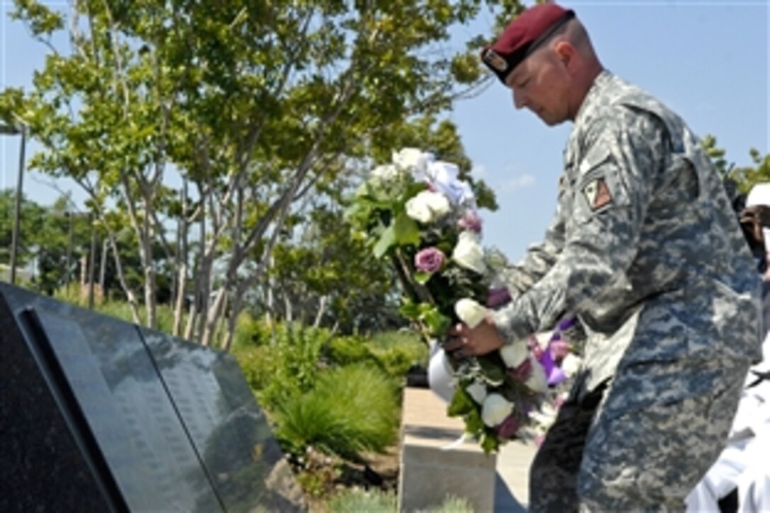 Army Staff Sgt. Dean Issacs, a disabled soldier suffering from a spinal cord injury, lays a wreath at the Pentagon Memorial, May 5, 2010, in honor of the victims of Sept. 11, 2001. The ceremony was part of the celebration for the inaugural Warrior Games, slated for May 10-14 in Colorado Springs, Colo. Rolling Thunder Inc., a veterans advocacy group known for their motorcycle rides across the country, also participated.