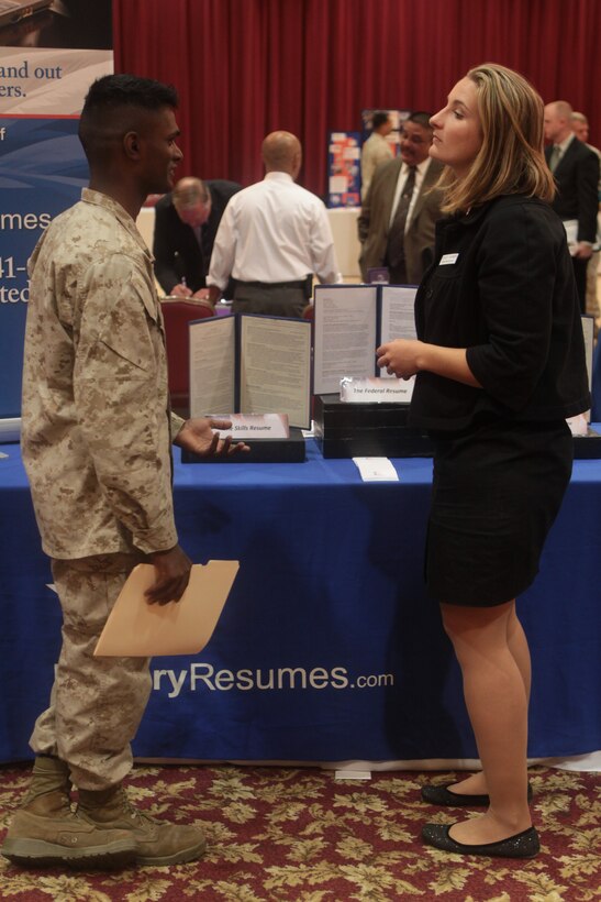 Cpl. Kittu Hoke, a bulk fuel specialist with Bulk Fuel Company, 7th Engineer Support Battalion, Combat Logistics Regiment 1, 1st Marine Logistics Group, speaks with Ashley Harmon, a manager with Military Resumes and editor with Civilian Job News, about resume types and necessities during a career expo hosted by CivilianJobs.com at the Pacific Views South Mesa Club here, Nov. 3.Approximately 300 active-duty and transitioning service members, retirees, veterans, reserve members and their families attended the event.