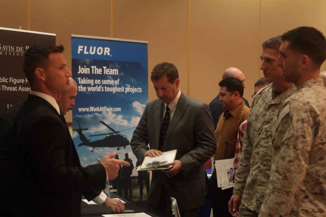David Baril, a representative for the Protective Security Division of Gavin De Becker & Associates, Inc., and major in the Marine Corps Reserve, talks to Marines about aspects of his company during a career expo hosted by CivilianJobs.com at the Pacific Views South Mesa Club here, Nov. 3. The event served as an opportunity for those with military affiliations to meet with local and national employers.