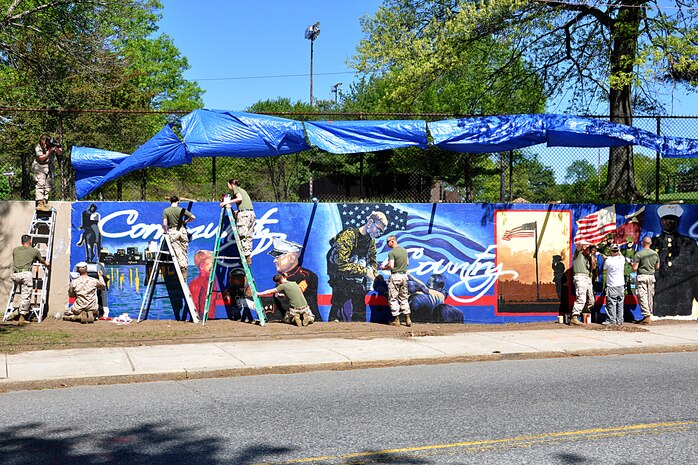 U. S. Marine Corps Lance Cpl. Pablo Morrison, Combat Reproduction Specialist, Marine Corps Base Quantico, Va., paints a Marine Corps themed mural at Hyde Park, Boston in support of Marine Week Boston, May 5, 2010. Marine Week Boston provides an opportunity to increase public awareness of the Marine Corps' value to our nation's defense and to preserve and mature the Corps' relationship with the American people.