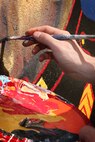 U. S. Marine Corps Cpl. Christopher Giannetti, Training and Education Command, Combat Camera Management, Marine Corps Base Quantico, Va., paints a Marine Corps themed mural at Hyde Park, Boston in support of Marine Week Boston, May 5, 2010. Marine Week Boston provides an opportunity to increase public awareness of the Marine Corps' value to our nation's defense and to preserve and mature the Corps' relationship with the American people.