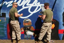 U. S. Marine Corps Lance Cpl. Pablo Morrison (left) and Cpl. Christopher Giannetti, Training and Education Command, Combat Camera Management, Marine Corps Base Quantico, Va., paint a Marine Corps themed mural at Hyde Park, Boston in support of Marine Week Boston, May 5, 2010. Marine Week Boston provides an opportunity to increase public awareness of the Marine Corps' value to our nation's defense and to preserve and mature the Corps' relationship with the American people.