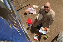 strator, Combat Visual Information Center, Marine Corps Base Quantico, Va., paints a Marine Corps themed mural at Hyde Park, Boston in support of Marine Week Boston, May 5, 2010. Marine Week Boston provides an opportunity to increase public awareness of the Marine Corps' value to our nation's defense and to preserve and mature the Corps' relationship with the American people.