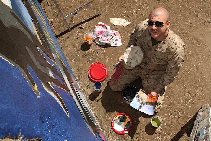 strator, Combat Visual Information Center, Marine Corps Base Quantico, Va., paints a Marine Corps themed mural at Hyde Park, Boston in support of Marine Week Boston, May 5, 2010. Marine Week Boston provides an opportunity to increase public awareness of the Marine Corps' value to our nation's defense and to preserve and mature the Corps' relationship with the American people.