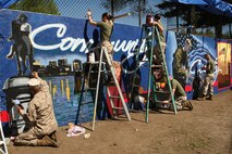 U. S. Marines paint a Marine Corps themed mural at Hyde Park, Boston in support of Marine Week Boston, May 5, 2010. Marine Week Boston provides an opportunity to increase public awareness of the Marine Corps' value to our nation's defense and to preserve and mature the Corps' relationship with the American people.