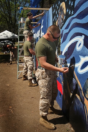 U. S. Marine Corps Lance Cpl. Pablo Morrison, Combat Reproduction Specialist, Marine Corps Base Quantico, Va., paints a Marine Corps themed mural at Hyde Park in support of Marine Week Boston, May 5, 2010. Marine Week Boston provides an opportunity to increase public awareness of the Marine Corps' value to our nation's defense and to preserve and mature the Corps' relationship with the American people.