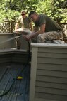 U. S. Marine Corps Corporals Jonathan Brimshaw (front) and Mikel Hensley of 3rd Battalion, 24th Marines, Johnson City, Tenn., clean the back patio during a project to help renovate the Robert J. Watson House, in Cambridge, Mass., in support of Marine Week Boston, May 5, 2010. Once Renovated, the Robert J. Watson House will be used as a shelter for troubled youth females. (Official U. S. Marine Corps photo by Lance Cpl. Natasha J. Combs)
