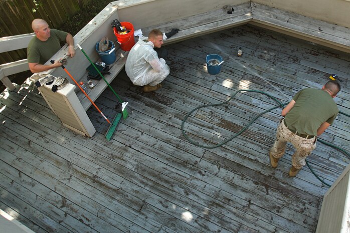 U. S. Marine Corps Staff Sgt. Matthew Stout (left), Lance Cpl. Trevor Salyer (center), and Cpl. Jonathan Brimshaw (right) of 3rd Battalion, 24th Marines, Johnson City, Tenn., clean the back patio during a project to help renovate the Robert J. Watson House, in Cambridge, Mass., in support of Marine Week Boston, May 5, 2010. Once Renovated, the Robert J. Watson House will be used as a shelter for troubled youth females. (Official U. S. Marine Corps photo by Lance Cpl. Natasha J. Combs)