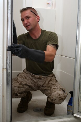U. S. Marine Corps Sgt. Allen Wawrzaszek of 3rd Battalion, 24th Marines, Johnson City, Tenn., cleans the shower of the upstairs bathroom during a project to help renovate the Robert J. Watson House, in Cambridge, Mass., in support of Marine Week Boston, May 5, 2010. Once Renovated, the Robert J. Watson House will be used as a shelter for troubled youth females. (Official U. S. Marine Corps photo by Lance Cpl. Natasha J. Combs)