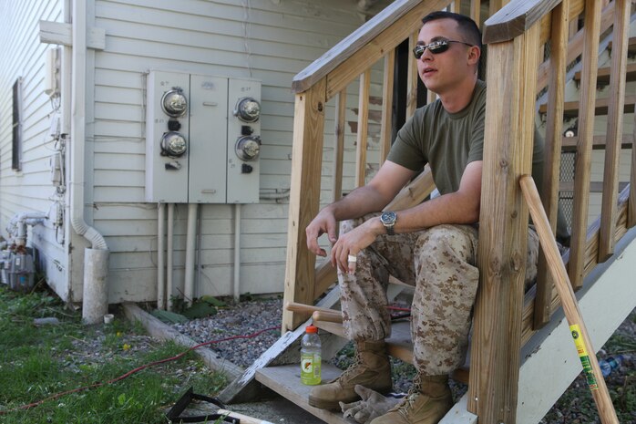 Sgt. Brian Knowles, a St. Louis native serving with Headquarters and Service Company, 3rd Battalion, 24th Marine Regiment, takes a well-deserved break while working on a house in Boston May 5, 2010. Marines with H and S Company assisted Habitat for Humanity Greater Boston, a non-profit organization that provides affordable housing for low-income families, by cleaning up the yard and helping construct a house.