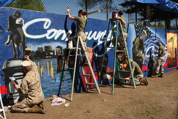 U. S. Marines paint a Marine Corps themed mural at Hyde Park, Boston in support of Marine Week Boston, May 5, 2010. Marine Week Boston provides an opportunity to increase public awareness of the Marine Corps' value to our nation's defense and to preserve and mature the Corps' relationship with the American people.