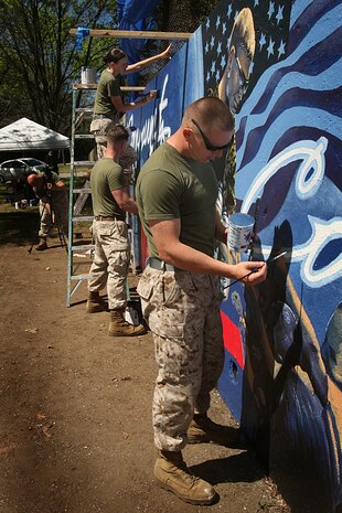 U. S. Marine Corps Lance Cpl. Pablo Morrison, Combat Reproduction Specialist, Marine Corps Base Quantico, Va., paints a Marine Corps themed mural at Hyde Park in support of Marine Week Boston, May 5, 2010. Marine Week Boston provides an opportunity to increase public awareness of the Marine Corps' value to our nation's defense and to preserve and mature the Corps' relationship with the American people.