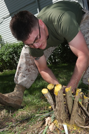 Lance Cpl. James Reese, a St. Louis native serving with Headquarters and Service Company, 3rd Battalion, 24th Marine Regiment, cuts into the remains of a bush before removing the roots in Boston May 5, 2010. Marines will participate in approximately 20 volunteer opportunities in the area for Marine Week Boston, a weeklong series of events that give Boston residents a chance to interact with Marines and learn about the Corps’ culture, history and current missions.