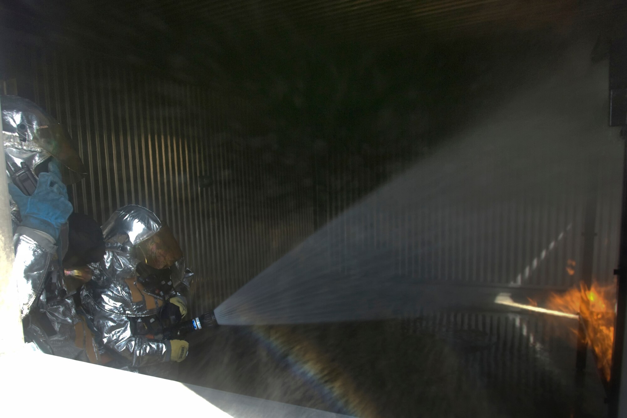 YOKOTA AIR BASE, Japan -- Col. Rafael Quezada, 374th Mission Support Group commander, participates in a live fire training exercise May 6. The 374th Civil Engineer Squadron and Fire Emergency Services Flight invited Col. Quezada to a simulated live fire structural exercise focusing on challenges firefighters encounter during real world situations. (U.S. Air Force photo/Osakabe Yasuo)
