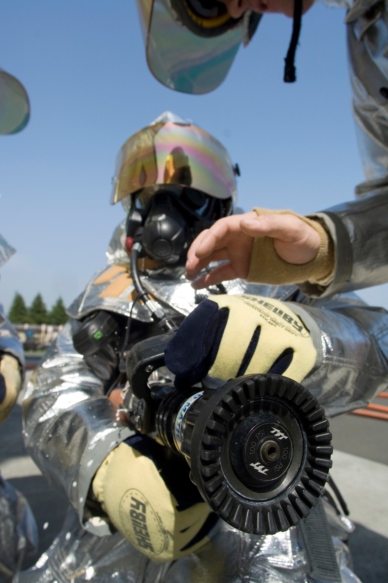 YOKOTA AIR BASE, Japan -- Col. Rafael Quezada, 374th Mission Support Group commander, learns how to operate a fire hose May 6 during a live fire training exercise. The 374th Civil Engineer Squadron and Fire Emergency Services Flight invites Col. Quezada to a simulated live fire structural exercise focusing on challenges firefighters encounter during real world situations. (U.S. Air Force photo/Osakabe Yasuo)