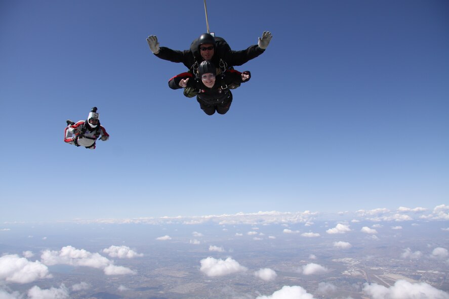 Canadian SkyHawk Tandem Master Dominic Dumont, top, falling with his tandem jump mate, Tech. Sgt. Diane Ducat, Blue Eagles Total Force honor Guard and Air National Guard 163rd Reconnaissance Wing public affairs. (Canadian Forces SkyHawks Parachute Team photo) 