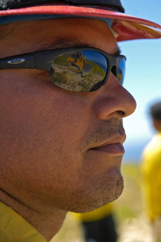 VANDENBERG AIR FORCE BASE, Calif. - Former Vandenberg Hot Shot Charlie Martinez, from the 30th Civil Engineer Squadron, watches as a member of the Vandenberg wildland fire dozer team makes a fire break here Tuesday, May 4, 2010. Vandenberg is the only installation in the Air Force with a fire dozer team. (U.S. Air Force photo/Senior Airman Andrew Lee) 
 