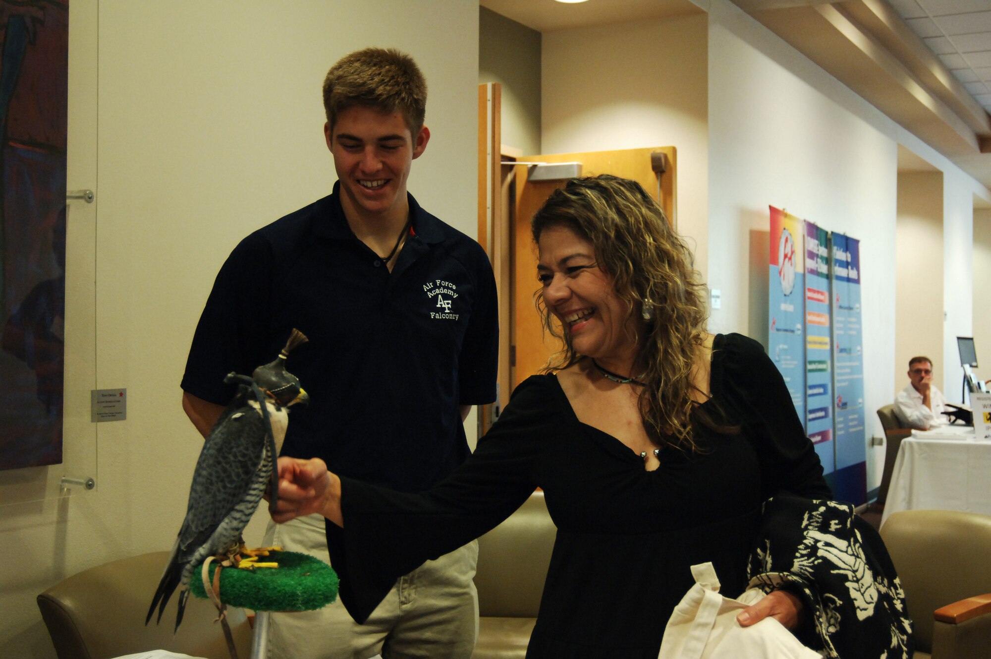 Angela Chavez, an education counselor for Mesa County Community College, meets Oblio, one of the Air Force Academy?s peregrine falcons, at the Native American Student Advocacy Institute conference at the University of New Mexico April 19. Cadet 4th Class Cameron Harris, a member of Cadet Squadron 14, talks about the Falconry program and his experience at the Academy. 