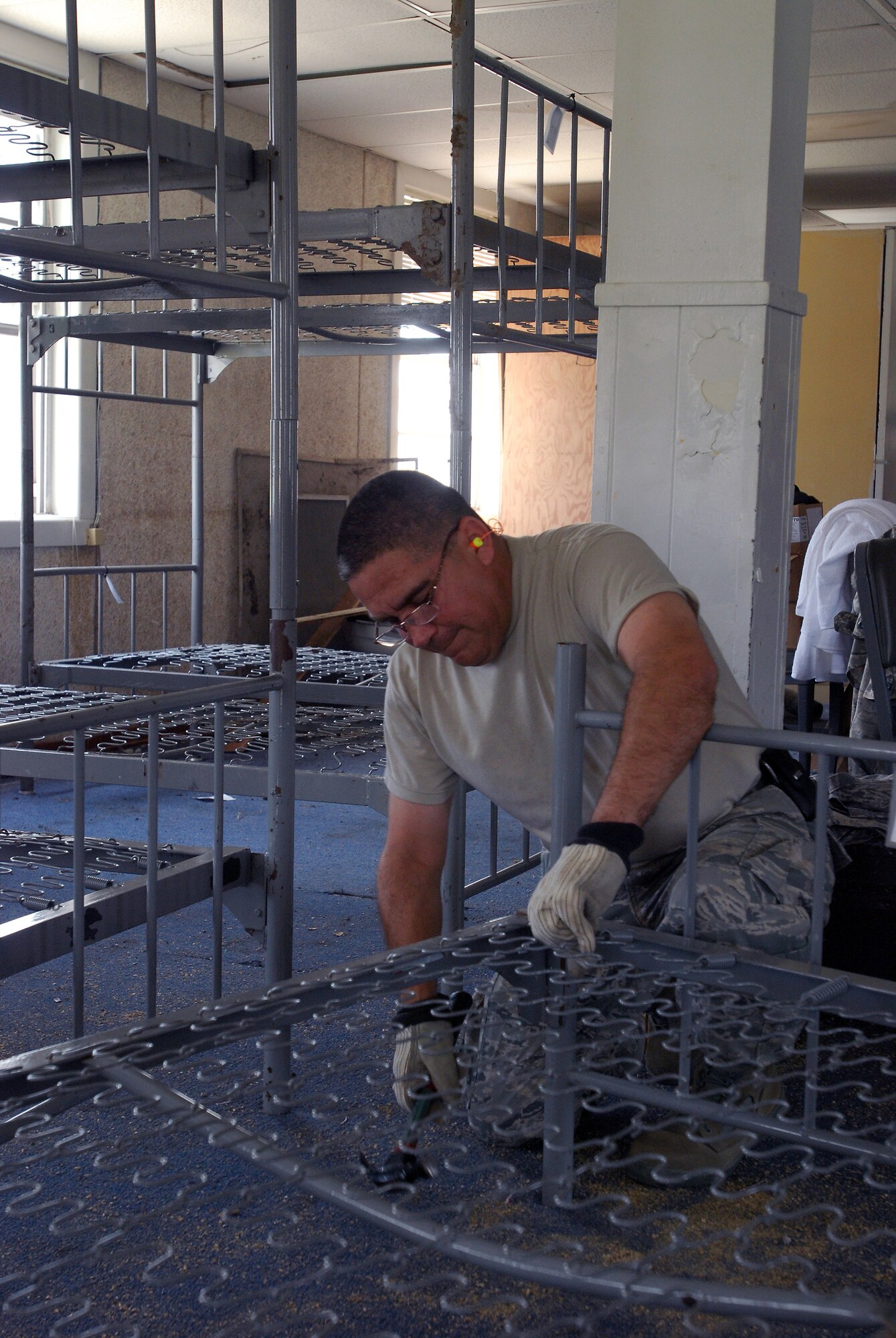 A group of visiting chief master sergeants, command chief master sergeants and first sergeants from all over Air Force Reserve Command and military trainign instructors from the 433rd Training Squadron, Lackland Air Force Base, Texas, assemble bunks in a WWII-era former dormatory, which will be part of the Air Force History and Traditions Museum here. The building was moved from the site of new housing and trainign facilities being built, escaping demolition. (U.S. Air Force photo/Airman 1st Class Brian McGloin)