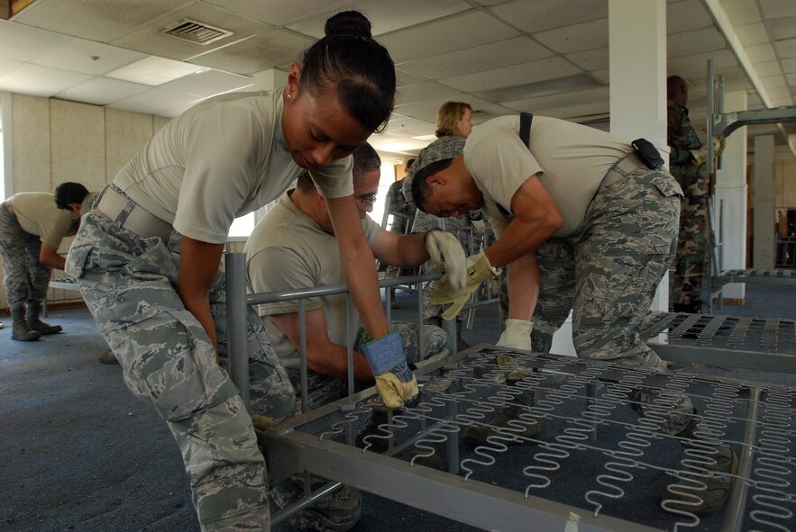 A group of visiting chief master sergeants, command chief master sergeants and first sergeants from all over Air Force Reserve Command and military trainign instructors from the 433rd Training Squadron, Lackland Air Force Base, Texas, assemble bunks in a WWII-era former dormatory, which will be part of the Air Force History and Traditions Museum here. The building was moved from the site of new housing and trainign facilities being built, escaping demolition. (U.S. Air Force photo/Airman 1st Class Brian McGloin)